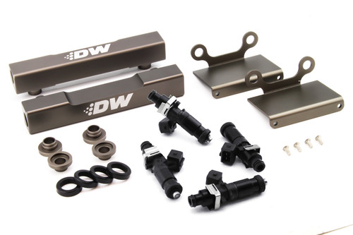 DeatschWerks fuel rail conversion kit with four black top feed injectors, brackets, spacers and mounting screws laid out on white background
