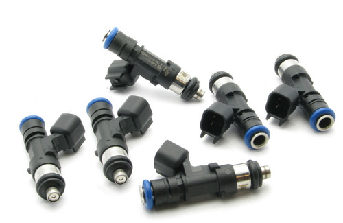 Set of six DeatschWerks 750cc fuel injectors for Nissan Patrol TB48, top angled view showing electrical connectors and nozzle tips.