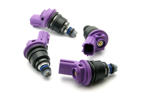 Set of four DeatschWerks 550cc side feed injectors, purple tops, black bodies, top down angled view