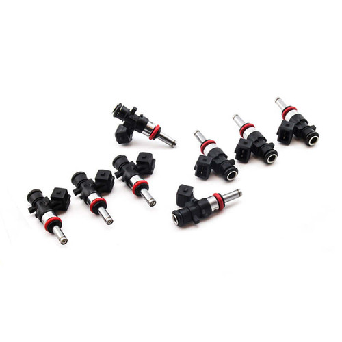 Set of 8 Deatschwerks 1250cc fuel injectors, angled view showing red O-rings and connector clips.
