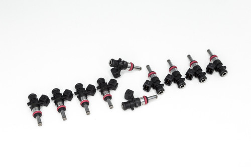DeatschWerks 1200cc fuel injectors, set of 10, arranged in two staggered rows showing black bodies with red O-rings and connector tips.