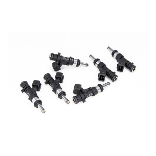 DeatschWerks 850cc top feed injectors, six units at angled view showing electrical connectors and nozzle tips