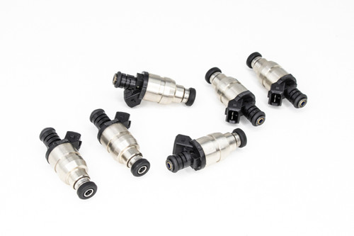 Set of six DeatschWerks 1800cc fuel injectors arranged in two rows, showing metal bodies and electrical connectors.