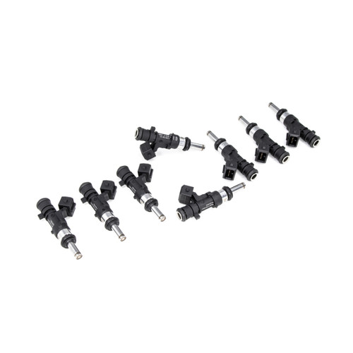 Set of 8 DeatschWerks 850cc fuel injectors arranged in a staggered row, angled view showing electrical connectors and nozzle tips.