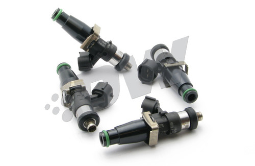Set of four DeatschWerks 2200cc fuel injectors for 4G63T engines, top down angled view showing electrical connectors and o-rings.