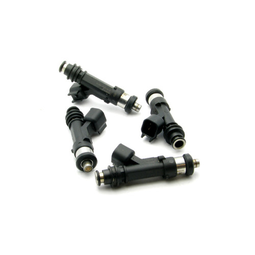 Set of four DeatschWerks 900cc fuel injectors for 89-90 Nissan 240sx KA24E, top angled view showing electrical connectors and o-rings