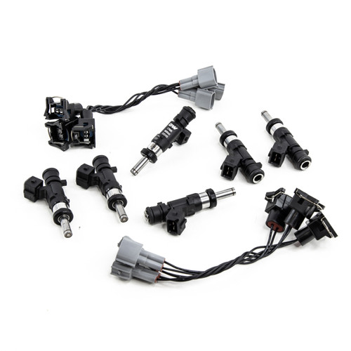 DeatschWerks 600cc fuel injector set of 6 for Toyota Tundra/4Runner, top angled view showing connectors and wiring harness