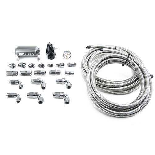 DeatschWerks DW400 return plumbing kit, fittings, gauge and braided steel hoses laid out on white background