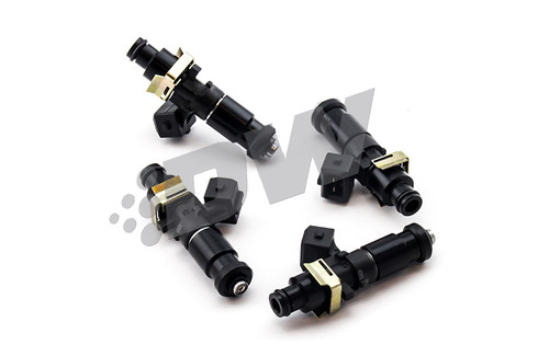 Set of four DeatschWerks EV14 1200cc fuel injectors, angled view showing black bodies and top connectors.