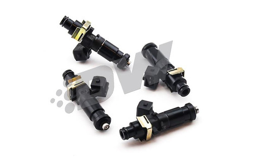 Set of four DeatschWerks EV14 1200cc fuel injectors, black bodies with brass clips, top down angled view.
