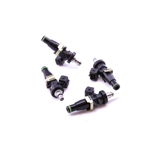 Set of four DeatschWerks EV14 1500cc fuel injectors, black bodies with green O-rings, angled view showing electrical connectors and nozzle tips.