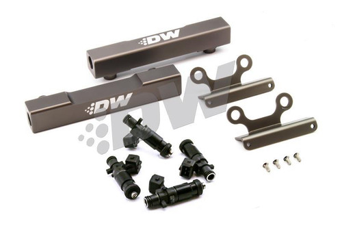 DeatschWerks WRX/STI top feed fuel rail kit with 1500cc injectors, mounting brackets, and hardware shown from above.