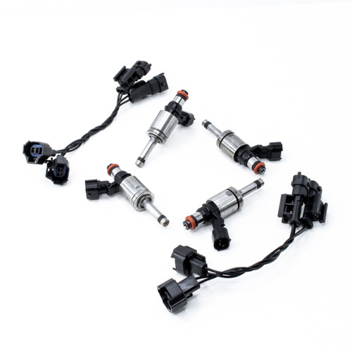 Set of four DeatschWerks 1700cc GDI fuel injectors with connector plugs, top down angled view