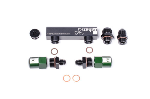 Radium Engineering 4 port fuel manifold with black fittings, green adapters, and copper sealing washers laid out