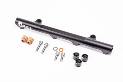 Radium Engineering Mazda 20B REW secondary fuel rail with mounting bolts, injector seals and copper washers laid out