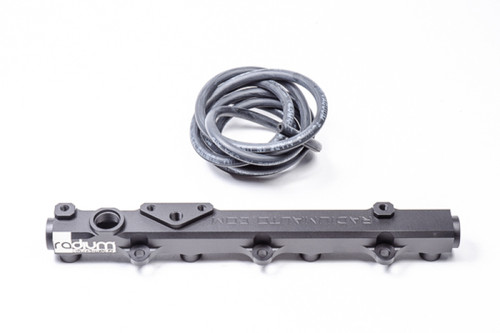 Radium Engineering fuel rail for Honda S2000, black billet bar with injector bungs and coiled hose beside it