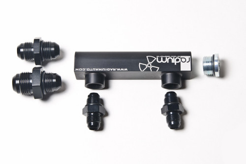 Radium Engineering black 4 port manifold with logo, four black AN fittings and one silver plug, top angle view