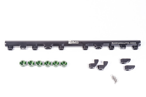 Radium Engineering top feed fuel rail kit for 2JZ-GTE, with mounting clips and green fittings shown.