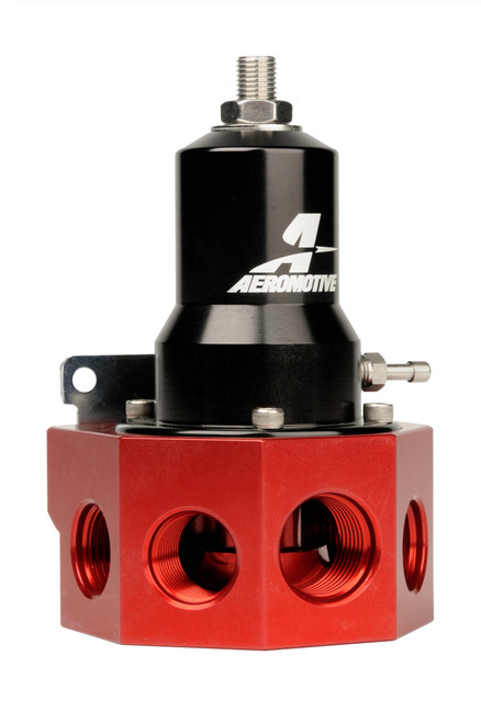 Aeromotive fuel pressure regulator, red hex body with black adjustable dome, AN-08/AN-10 ports and vacuum barb visible.