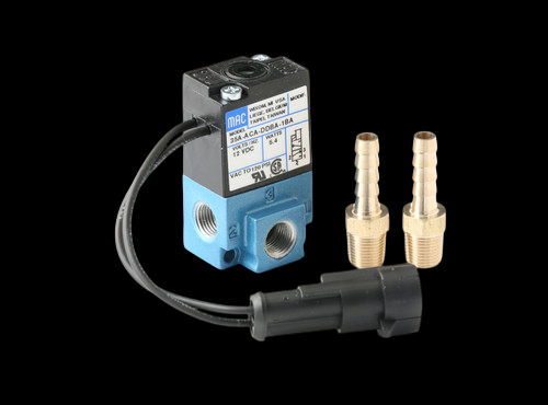 GFB G-Force solenoid valve, angled view with wiring harness, plus two brass hosetail fittings and connector plug.
