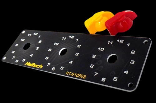 Haltech Triple Switch Panel Kit with numbered rotary dials, yellow and red knobs above, angled view.