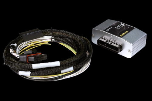 Haltech HPI8 8 channel igniter, silver box with connector, coiled braided wiring harness beside it