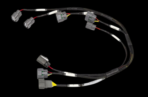 Haltech Nissan RB twin cam late model ignition sub harness with six connectors on braided wiring.