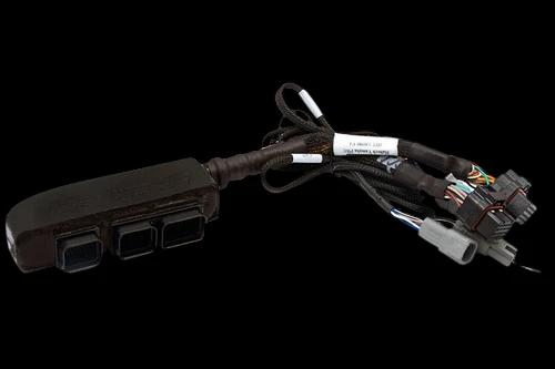 Haltech Elite 1500 plug-n-play adaptor harness, angled view showing ECU connector block and wiring pigtails