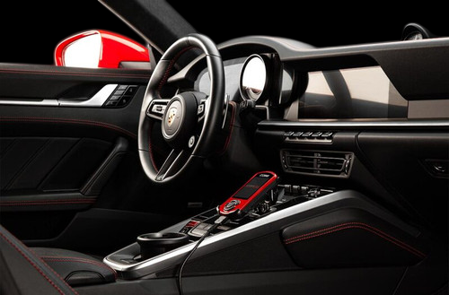 Cobb AccessPORT V3 mounted near shifter in Porsche 911 992 Carrera interior with red accents
