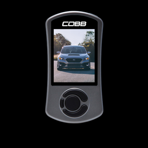 Cobb AccessPORT V3 handheld tuner, front view, screen shows a Subaru WRX, control dial below display