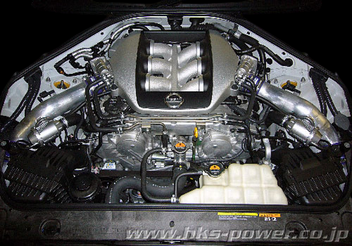 HKS SSQV4 BOV kit installed in Nissan GT-R R35 engine bay, polished piping visible on both turbos