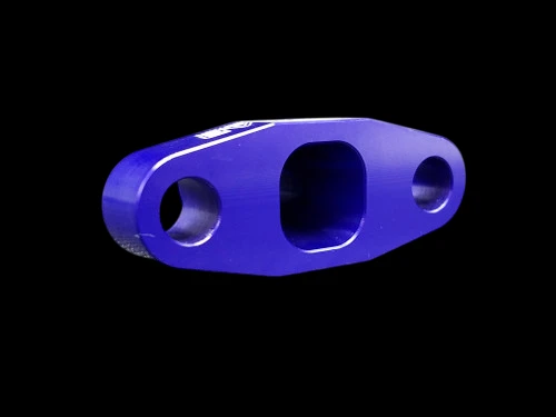Purple anodized BL billet T3/T4 turbo oil drain flange, angled top view showing three machined ports