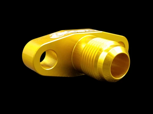 Gold billet T3/T4 turbo oil drain flange, angled front view showing threaded fitting and mounting bolt holes.