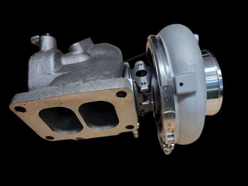K31 turbocharger replacement for Detroit Diesel Series 60, side view showing turbine housing and exhaust flange with mounting bolt holes