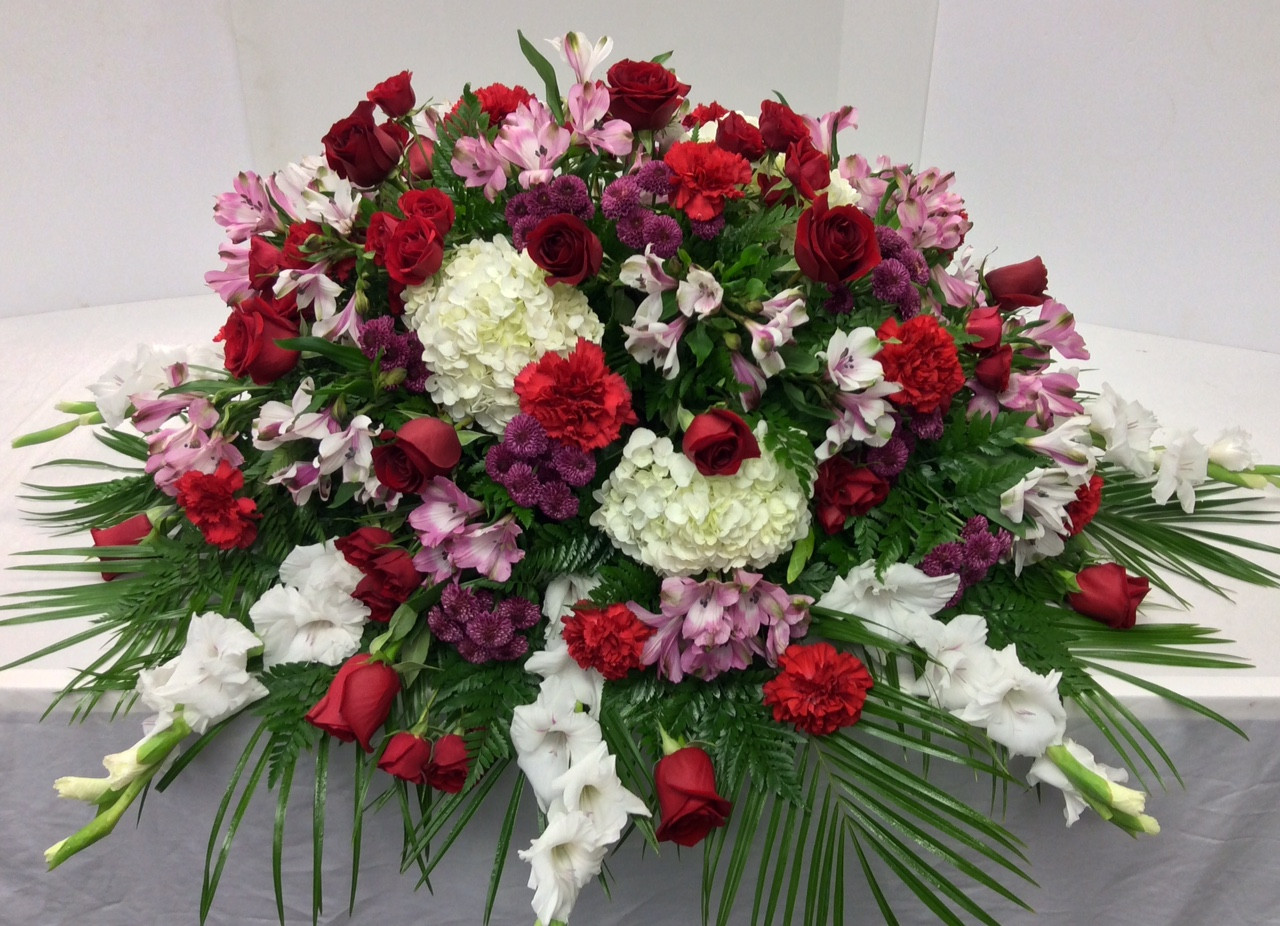 1 2 Couch Gardeny Jewel Tone Casket Spray Centerville Florists
