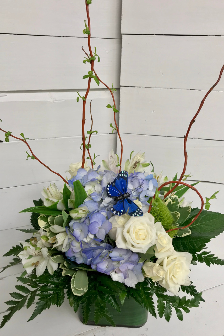 Blue and White Garden Centerpiece featuring hydrangea and roses by  Carithers Flowers Atlanta
