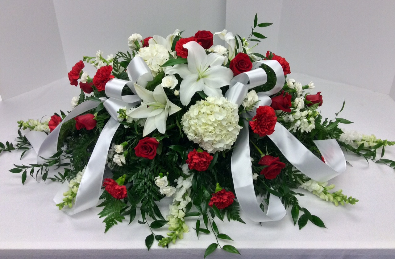 1/2 couch casket spray in blues and whites Centerville Florists