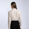 A women's button-up shirt in a cream and brown check pattern, featuring a collar and long sleeves.