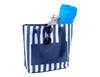A navy and white striped tote bag with a drink bottle, a blue towel, and sunglasses inside.