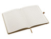 An open A5 notebook featuring blank lined pages with a light cream colour and a ribbon bookmark.