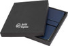 A gift box containing two navy A5 notebooks, presented in a sleek black packaging with a logo.