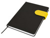 A black A5 notebook with a yellow elastic band closure and white pages. It features a branding logo.