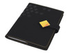 A black A5 portfolio with a geometric design and a yellow accent, featuring a clasp closure and stitching details.
