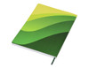 A green and yellow patterned A5 notebook with a soft cover and an attached ribbon bookmark, featuring a logo.