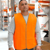 An orange safety vest is worn by a person in a warehouse setting, featuring a simple design and a logo.