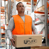 A man wearing an orange high-visibility safety vest holds a cardboard box in a warehouse setting.