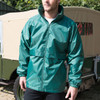 A green rain jacket with a high collar and zip front, featuring elastic cuffs and a relaxed fit.