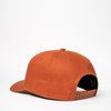 A rust-coloured snapback cap with a solid design and a branding logo at the back.