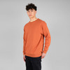 An orange crewneck jumper stands out against a plain background, worn by a model with curly hair.