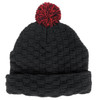 A black textured beanie with a red pom pom on top. It features a folded brim and has a branding logo.